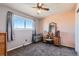 Comfortable bedroom with a large window, neutral walls, and a ceiling fan at 15373 Uravan St, Brighton, CO 80601