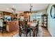 Elegant dining area with wooden table and a sliding glass door at 15373 Uravan St, Brighton, CO 80601