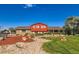 Charming two-story home with unique barn-inspired design, landscaped front yard and inviting porch at 15373 Uravan St, Brighton, CO 80601