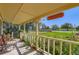 Comfortable front porch with seating, offering views of the landscaped yard at 15373 Uravan St, Brighton, CO 80601