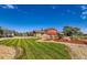 Expansive front yard with lush landscaping and a well-maintained lawn at 15373 Uravan St, Brighton, CO 80601
