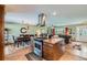 Open-concept kitchen with a center island, stainless steel appliances, and a view of the dining and living areas at 15373 Uravan St, Brighton, CO 80601