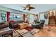 Inviting living room with large windows, hardwood floors, and cozy seating arrangements at 15373 Uravan St, Brighton, CO 80601