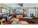 Cozy living room featuring neutral tones, comfortable furnishings and stylish ceiling fan at 15373 Uravan St, Brighton, CO 80601