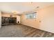 Cozy living room with a stone fireplace, a new window, and carpeted floors at 15373 Uravan St, Brighton, CO 80601