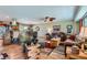 Open-concept living room blending seamlessly with the dining area, with stylish furnishings at 15373 Uravan St, Brighton, CO 80601