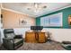 Office area with a window, a ceiling fan, and a comfortable chair, ideal for a workspace at 15373 Uravan St, Brighton, CO 80601