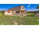 Outbuilding on green grass with red trim and barn roof, small covered porch, fenced yard, and extra storage space at 15373 Uravan St, Brighton, CO 80601