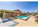 Backyard pool with a slide, surrounded by a patio, creating an ideal outdoor retreat at 15373 Uravan St, Brighton, CO 80601
