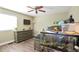 Bedroom featuring a turtle aquarium, dresser with TV, and a ceiling fan at 4520 S Jebel Ct, Aurora, CO 80015