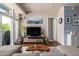 Inviting living room with a TV, lots of plants, and a view of the outdoor balcony at 1488 Madison St # 307, Denver, CO 80206