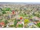Aerial view of a home nestled near Clear Creek, surrounded by lush greenery and mature trees at 4095 Field Dr, Wheat Ridge, CO 80033