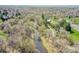 Aerial view of community, showcasing winding river, lush green trees, park and walking trails at 4095 Field Dr, Wheat Ridge, CO 80033