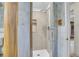 Bathroom with a shower featuring glass doors, unique accent wood, and tile at 4095 Field Dr, Wheat Ridge, CO 80033