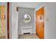 Inviting foyer featuring a unique round window, stylish tile flooring, and a solid wood door at 4095 Field Dr, Wheat Ridge, CO 80033