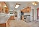 Well-lit kitchen boasts tile floors, wood cabinets, and modern stainless steel appliances at 4095 Field Dr, Wheat Ridge, CO 80033