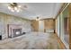 Spacious living room with wood paneled walls, fireplace, and large windows at 4095 Field Dr, Wheat Ridge, CO 80033