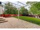 Paver patio area with pergola, stone steps, surrounded by fenced yard at 10364 Ravenswood Way, Highlands Ranch, CO 80130