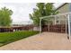 Paved patio with pergola and backyard that is surrounded by a wooden fence at 10364 Ravenswood Way, Highlands Ranch, CO 80130