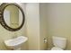 Powder room with pedestal sink and toilet at 10364 Ravenswood Way, Highlands Ranch, CO 80130