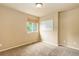 Cozy bedroom featuring neutral walls, plush carpeting, and a window with natural light at 10364 Ravenswood Way, Highlands Ranch, CO 80130