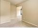 A comfortably carpeted room with an open doorway and neutral wall color at 10364 Ravenswood Way, Highlands Ranch, CO 80130
