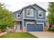 Charming two-story home with brick accents, manicured lawn, and attached garage at 10364 Ravenswood Way, Highlands Ranch, CO 80130