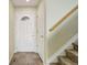 Entryway with tile flooring, a decorative front door, and a staircase leading upstairs at 10364 Ravenswood Way, Highlands Ranch, CO 80130