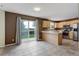 Open kitchen featuring light wood cabinets, stainless steel appliances, tile floors, and sliding glass door to the backyard at 10364 Ravenswood Way, Highlands Ranch, CO 80130