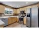 Bright kitchen with stainless steel appliances, light wood cabinets and tile flooring at 10364 Ravenswood Way, Highlands Ranch, CO 80130