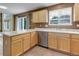 Kitchen with stainless steel dishwasher, sink and light wood cabinets at 10364 Ravenswood Way, Highlands Ranch, CO 80130