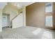 Open living room with staircase, large windows, and neutral carpet at 10364 Ravenswood Way, Highlands Ranch, CO 80130
