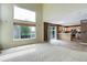 Open-concept living room with high ceilings, large windows, and access to the kitchen at 10364 Ravenswood Way, Highlands Ranch, CO 80130