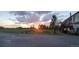 Beautiful sunset view over a large backyard with mature trees and green lawn at 43400 Somerset Ct, Elizabeth, CO 80107