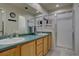 Bright bathroom featuring a double sink vanity and a glass-enclosed shower at 43400 Somerset Ct, Elizabeth, CO 80107