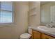 Cozy half-bath with a sink, toilet, and window for natural light at 43400 Somerset Ct, Elizabeth, CO 80107