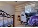 Cozy bedroom featuring a wrought iron bed frame, built-in shelves, and a bright window with natural light at 43400 Somerset Ct, Elizabeth, CO 80107