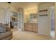 Bonus room with a cabinet featuring glass shelving, with a view into the kitchen at 43400 Somerset Ct, Elizabeth, CO 80107