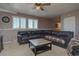 Finished basement living area with a black leather sofa and mounted television at 43400 Somerset Ct, Elizabeth, CO 80107