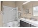 Cozy bathroom featuring a shower-tub combo, modern vanity, and neutral color scheme at 837 E 17Th Avenue # 2K, Denver, CO 80218