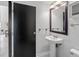 Quaint bathroom with a pedestal sink, bright lighting, and classic fixtures at 837 E 17Th Avenue # 2K, Denver, CO 80218