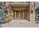Inviting entrance with stone accents, lighting, and well-maintained landscaping at 837 E 17Th Avenue # 2K, Denver, CO 80218