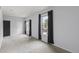 Bright living room featuring neutral carpet, three windows with blinds, and dark curtains at 837 E 17Th Avenue # 2K, Denver, CO 80218
