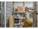 Storage room featuring shelving with household supplies, boxes, and bins behind a chain-link fence at 837 E 17Th Avenue # 2K, Denver, CO 80218