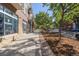 Charming street view of a well-maintained building with a retail shop and landscaped sidewalk at 837 E 17Th Avenue # 2K, Denver, CO 80218