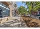 Charming street view of a well-maintained building with a retail shop and landscaped sidewalk at 837 E 17Th Avenue # 2K, Denver, CO 80218