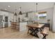 Bright kitchen with an eat-in area, white shaker cabinets, and wooden dining table at 2614 Hillcroft Ln, Castle Rock, CO 80104