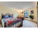Sunny bedroom with carpeted floors, wrought iron bedframe, and large window at 8155 Everett E St, Arvada, CO 80005