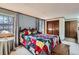 Comfortable bedroom with soft natural light, wood floors and a charming quilt on the bed at 8155 Everett E St, Arvada, CO 80005
