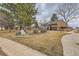 Lawn featuring a paved walkway, landscaping and partial view of brick building at 8155 Everett E St, Arvada, CO 80005